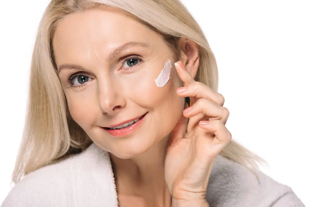 smiling mature woman applying cosmetic cream isola 2021 08 29 17 02 27 utc 1 1024x683.jpg