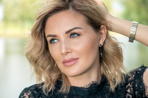 Middle aged woman has no wrinkles thanks to cosmetic treatments to smooth her skin.