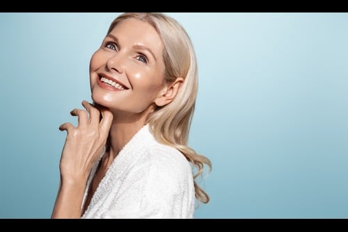 Menopausal woman manages to maintain glowing skin with deliberate skincare.